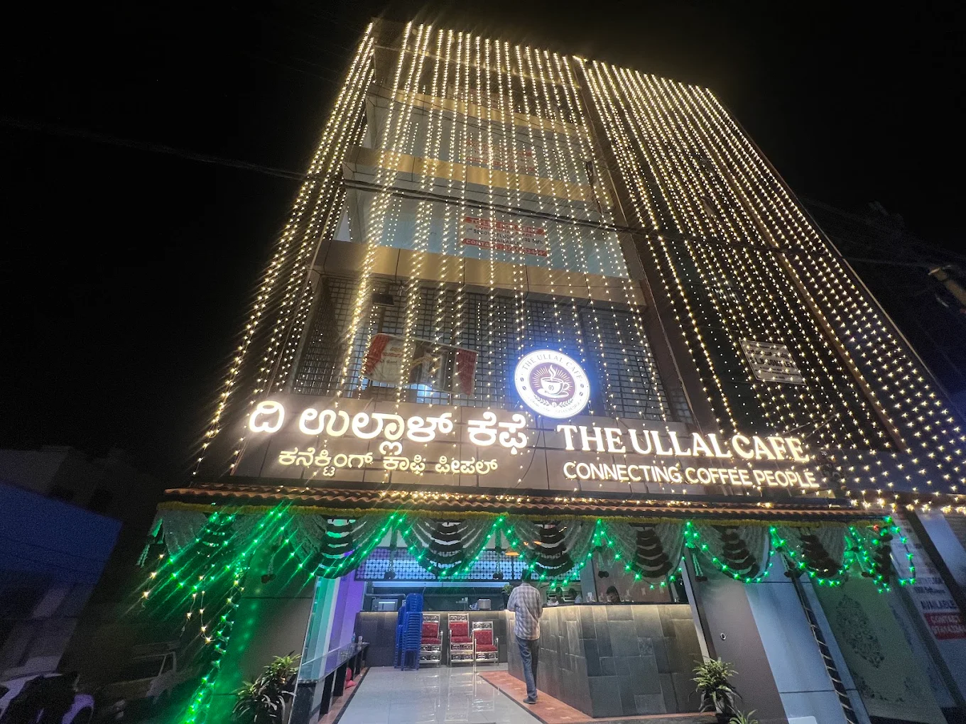 The Ullal Cafe storefront lit up in the evening